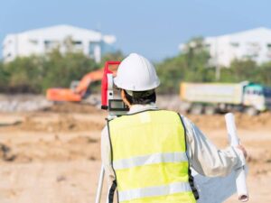 Land surveyor reviewing a commercial property site during an ALTA survey